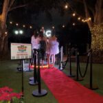Premier DJ Services 360 Photo Booth experience with red carpet and VIP stanchions at an outdoor event